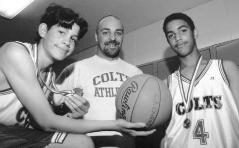student basketball players with their coach