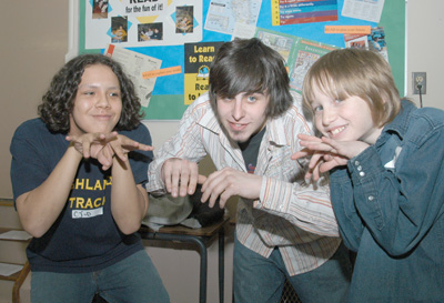 A Highlands Junior High School student (left) and a potential newbie to Highlands (right) join comedian Douglas Wheeler in a skit created during the school’s third annual Young Reader’s Conference.—