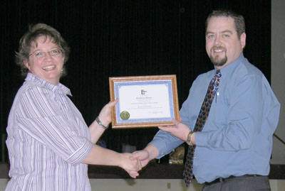 Dick Richards, District Representative for North East, presents Barbara Burns with an Ed Trust project grant.