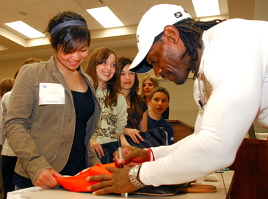 Retired Edmonton Eskimo Henry "Gizmo" Williams meets with students attending the Students Stepping Forward Youth Action Conference, sponsored by the Society for Safe and Caring Schools and Communities.