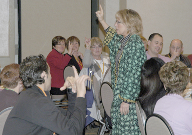 Keynote speaker Carol Boothroyd leads administrators through an exercise during her presentation on humour, wellness and stress.